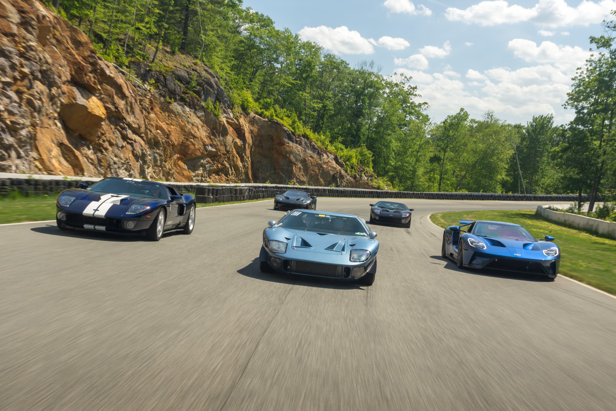 Five Ford GT40s lined up on track — historic motorsport photography