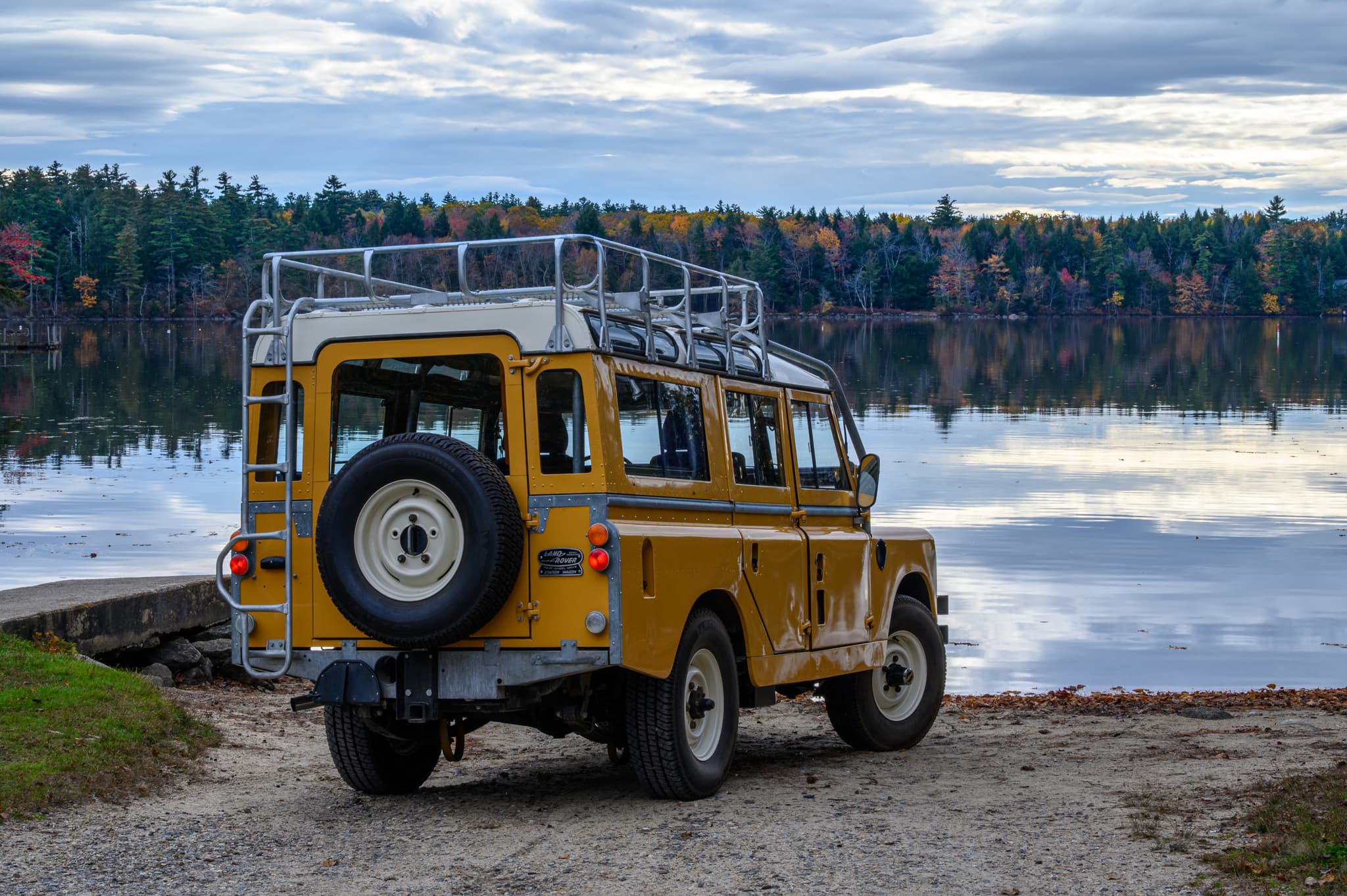 1961 Land Rover Series II reflected in a New England lake — automotive photography
