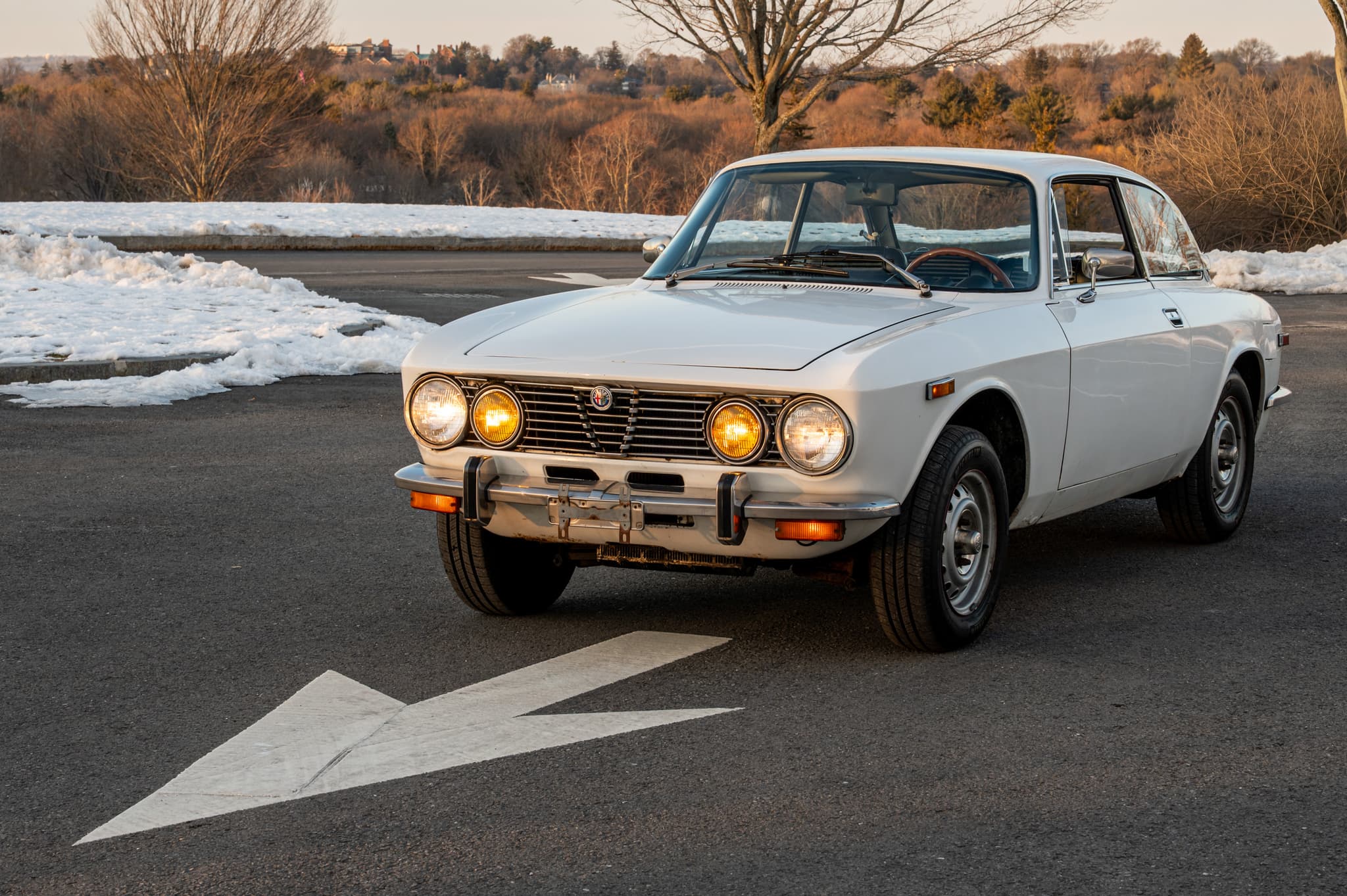 1974 Alfa Romeo GTV 2000 in snow with amber headlights — winter automotive photography